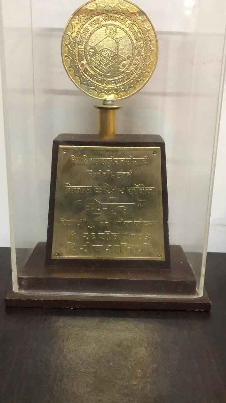 Rajani Shantaram Pandit honor trophy with golden emblem and wooden base